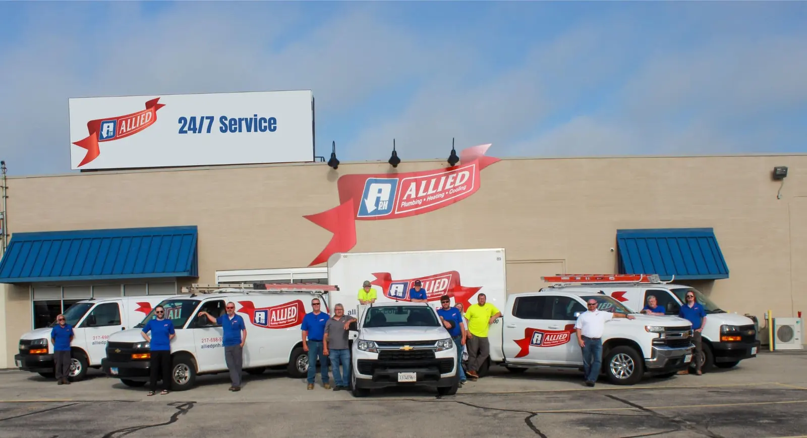 The Allied Plumbing, Heating & Cooling team and service fleet lined up outside the Springfield shop