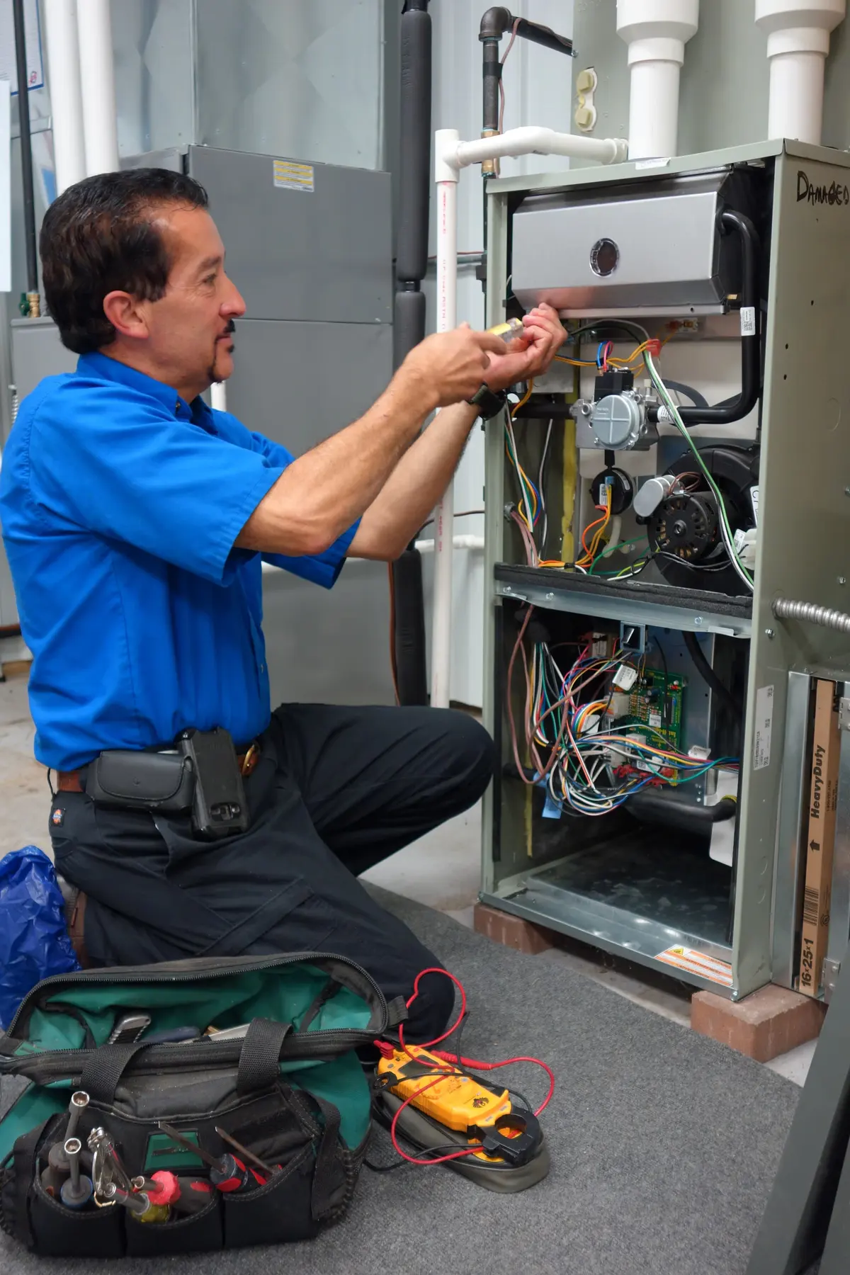 Allied technician performing a furnace tune-up and safety inspection